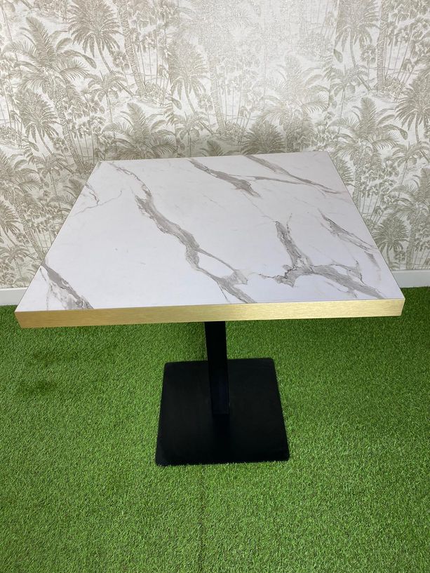 Mesa imitación mármol blanco con canto dorado y pie negro