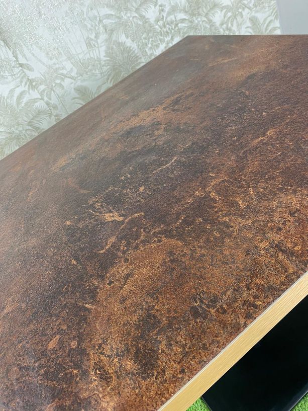 mesa con tablero tipo óxido y pie negro